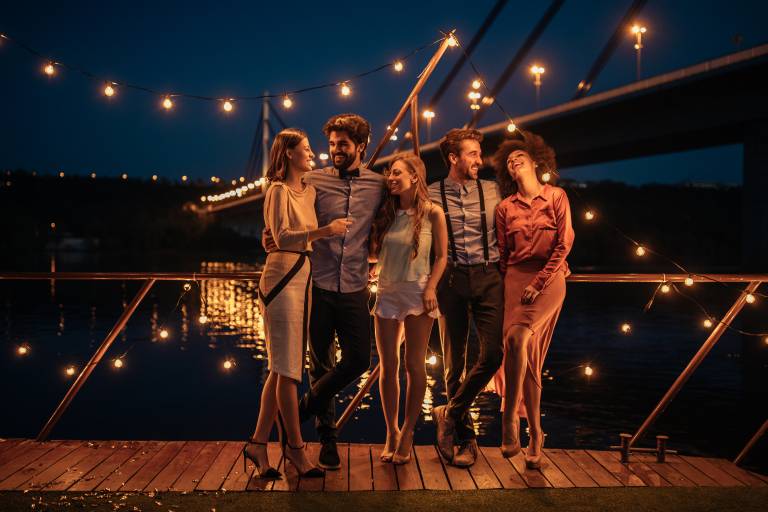 Shot of a group of friends having a great time at a boat party